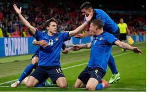 Federico Chiesa  diserbu para pemain Italia lainnya setelah mencetak gol pertama ke gawang Austria