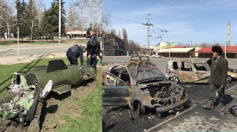 Seorang pria berjalan melewati mobil yang terbakar dan beberapa orang lainnya mengamati rudal di lokasi serangan rudal, di stasiun kereta api, di tengah invasi Rusia ke Ukraina, di Kramatorsk