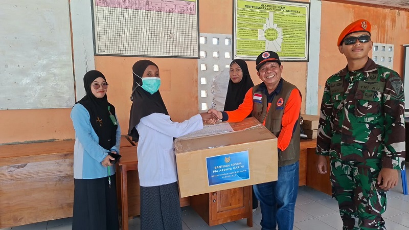 Direktur Penanganan Darurat Wilayah III BNPB, Nelwan Harahap (baju orange rompi) menyerahkan bantuan obat-obatan dan perangkat jaringan telekomunikasi kepada perwakilan tenaga medis serta warga terdampak gempa M 7,7 Flores, di Desa Samporong, Kecamatan Alok, Kabupaten Sikka, Nusa Tenggara Timur, Minggu (23/8) (Foto: Bidang Komunikasi Kebencanaan/Danung Arifin)